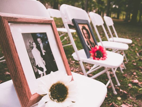 Framed photo on white chairs at a celebration of life gathering