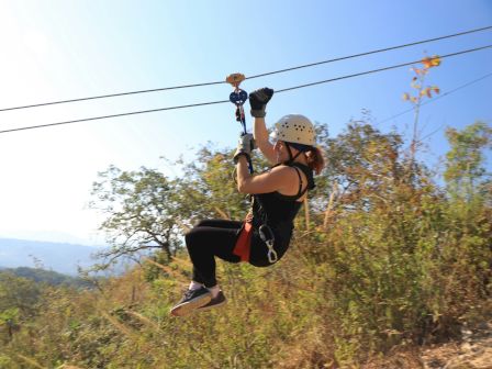 Guest ziplining through the trees
